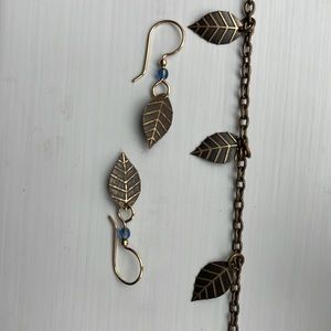 Gold colored necklace 7 small  leaves  1 1/2 “ apart on chain & matching earring